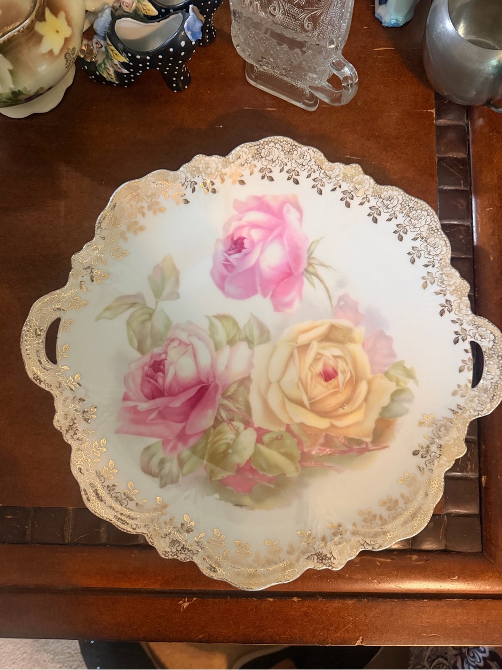 Floral Porcelain Scallop Plate with Pink and Yellow Roses and gold trim.